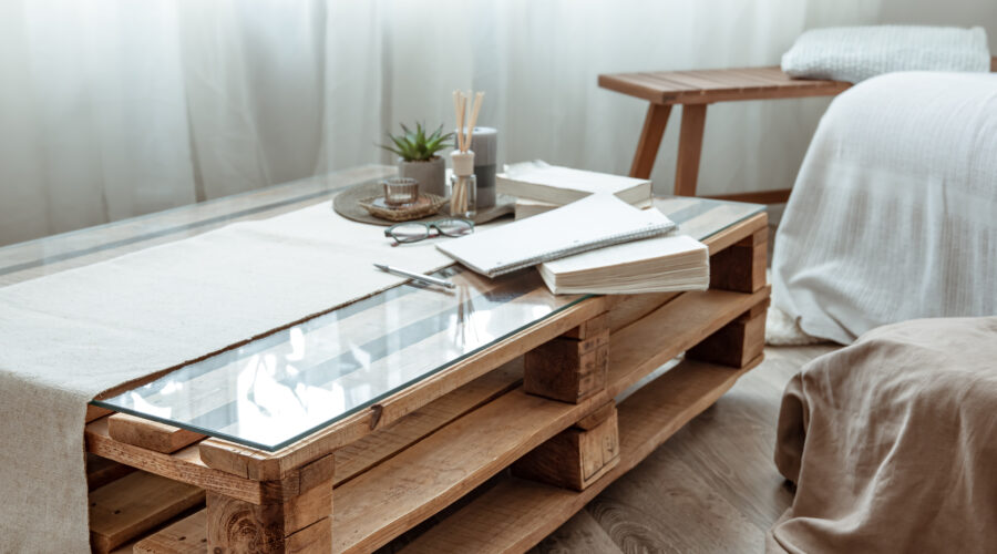 Part of the interior of a cozy room with a small table with books
