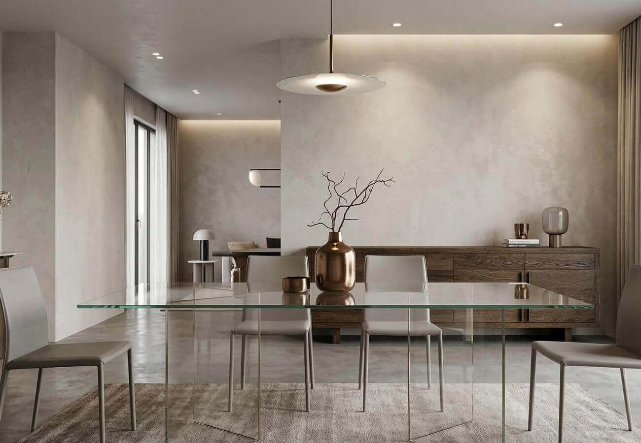 A glass contemporary dining table paired with a heavy wooden sideboard to balance visual weight.