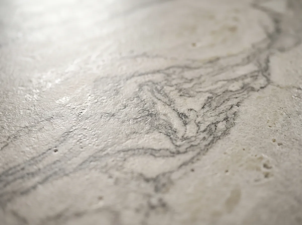 Close texture detail of a sintered stone dining table surface with a natural veined pattern
